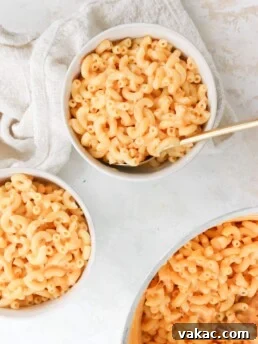5 Ingredient Creamy Cottage Cheese Mac and Cheese in three white bowls on a white table