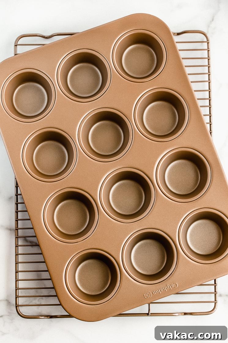 The Ultimate Baking Tool Guide 3 A muffin pan and cooling rack stacked on top of each other on top of a marble surface.