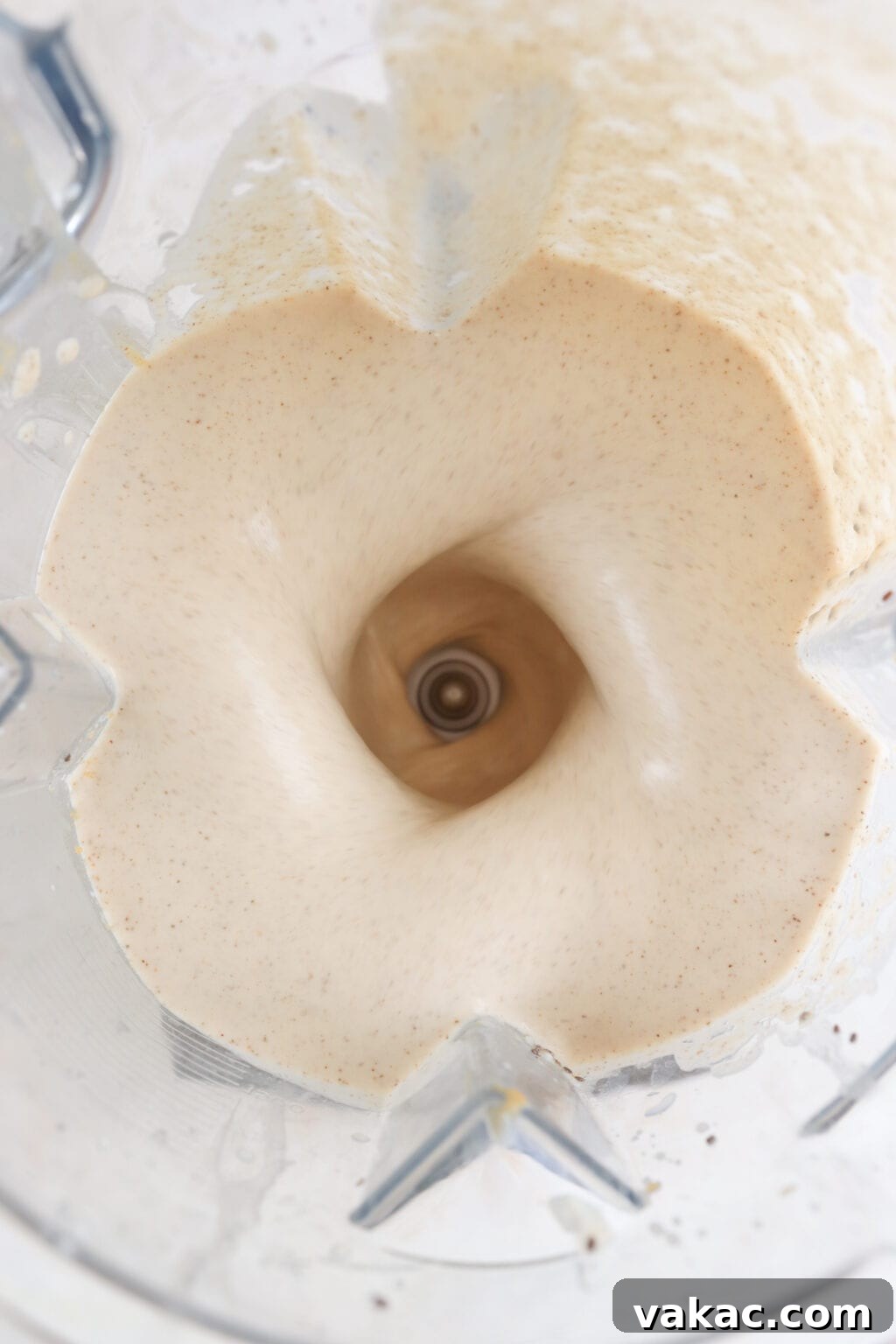Ingredients for a healthy peanut butter banana smoothie blended in a blender
