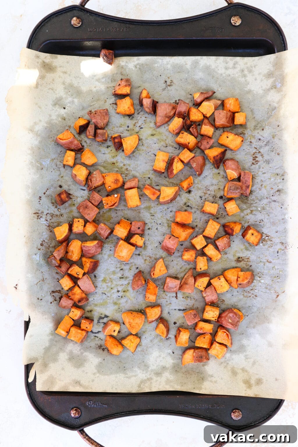 Comforting Slow Cooker Sweet Potato and Turkey Chili 3 Cubed sweet potatoes tossed with avocado oil, salt, and pepper, spread on a parchment-lined baking sheet, ready for roasting.