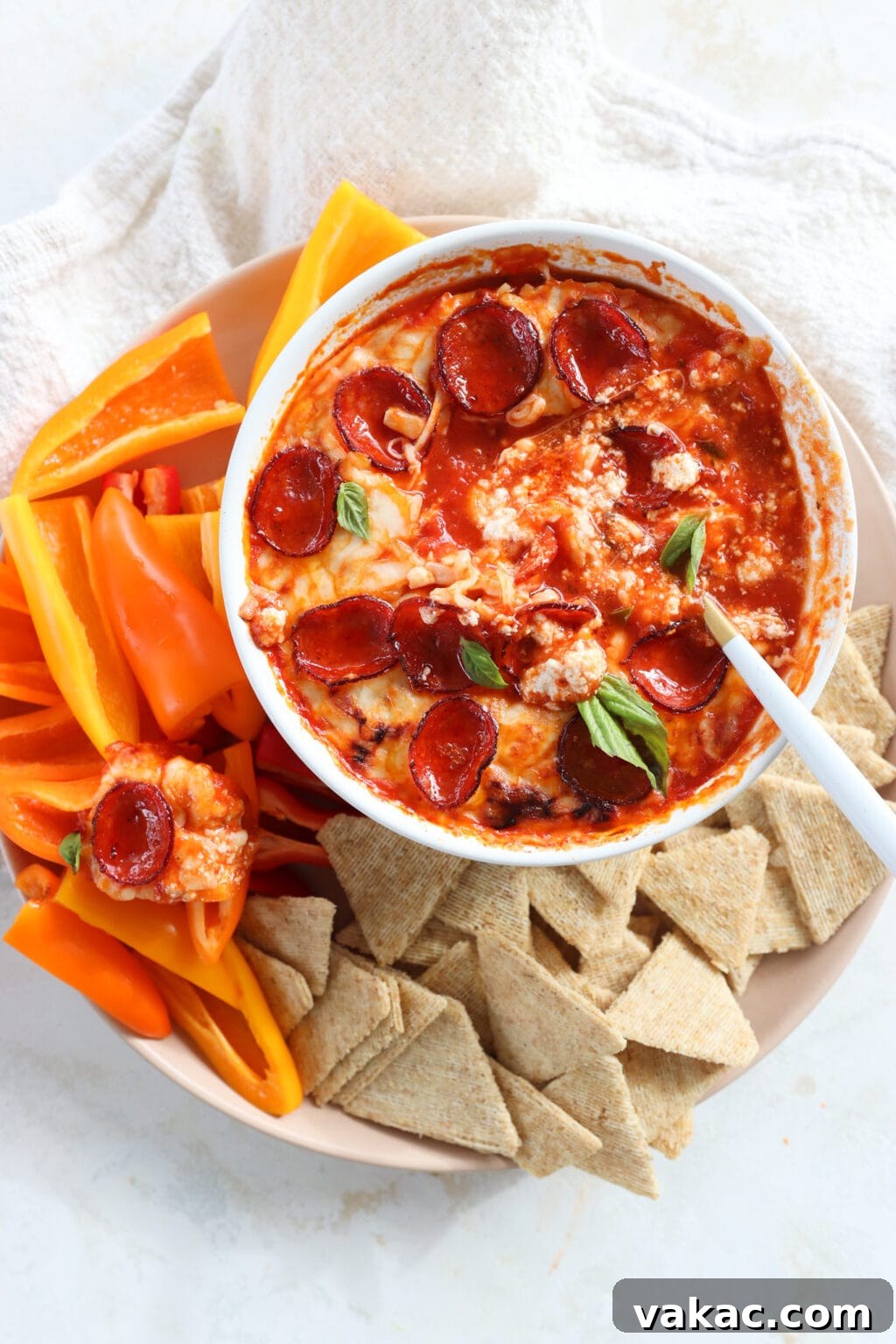 Speedy Cottage Cheese Pizza Dip Bake 2 Quick Baked Cottage Cheese Pizza Bowl Dip in a white dish with peppers and chips on the side