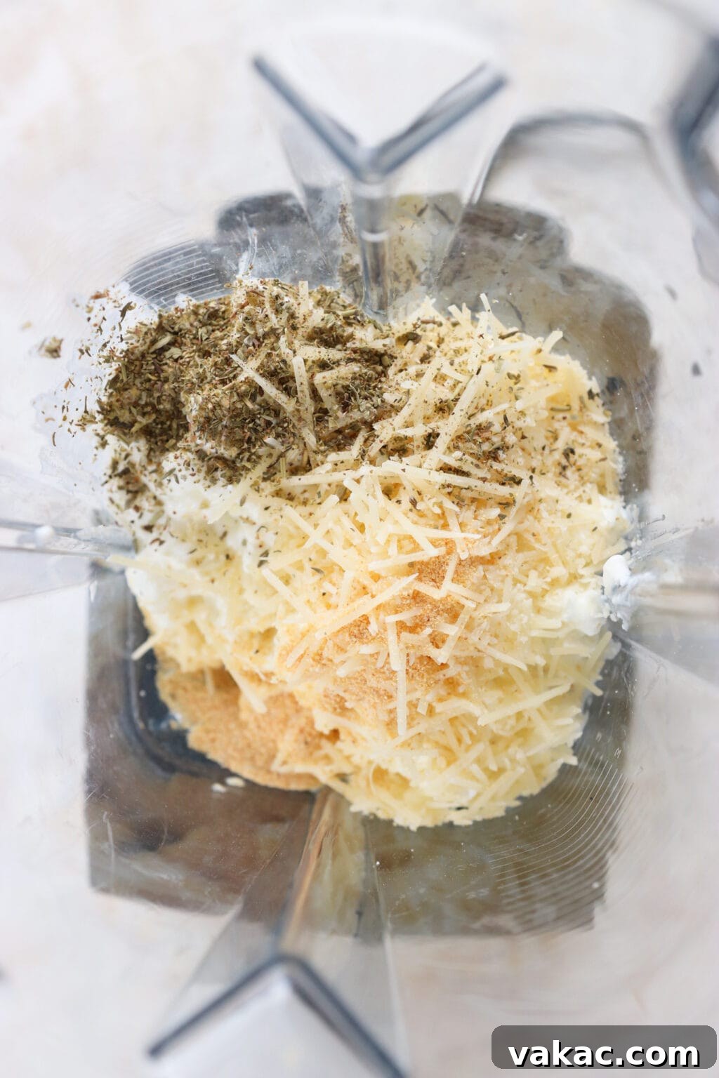 Speedy Cottage Cheese Pizza Dip Bake 4 Ingredients for Quick Baked Cottage Cheese Pizza Bowl Dip unblended in a blender, including cottage cheese, parmesan cheese, garlic powder, Italian seasoning, marinara sauce, mozzarella cheese, turkey pepperoni or pepperoni