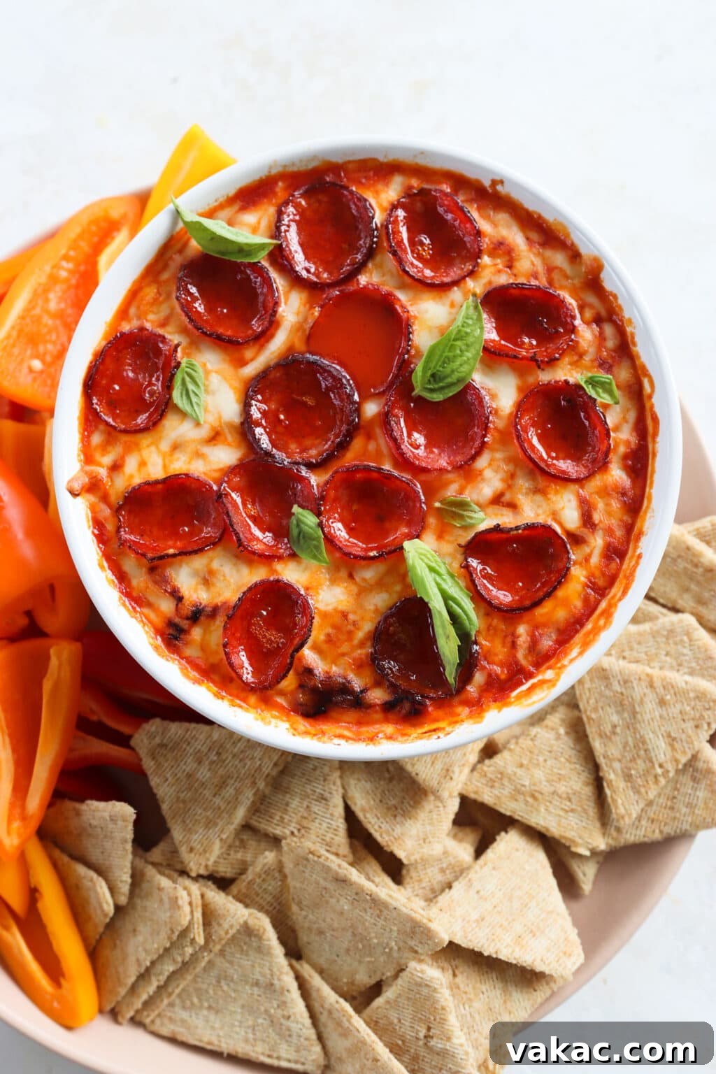 Speedy Cottage Cheese Pizza Dip Bake 8 Quick Baked Cottage Cheese Pizza Bowl Dip in a white dish with peppers and chips on the side