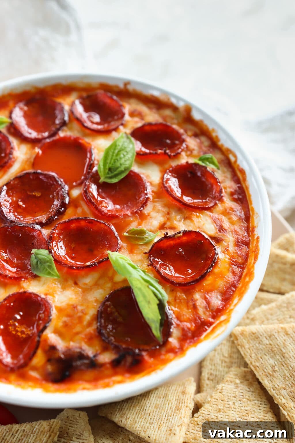 Speedy Cottage Cheese Pizza Dip Bake 9 Quick Baked Cottage Cheese Pizza Bowl Dip in a white dish with chips on the side