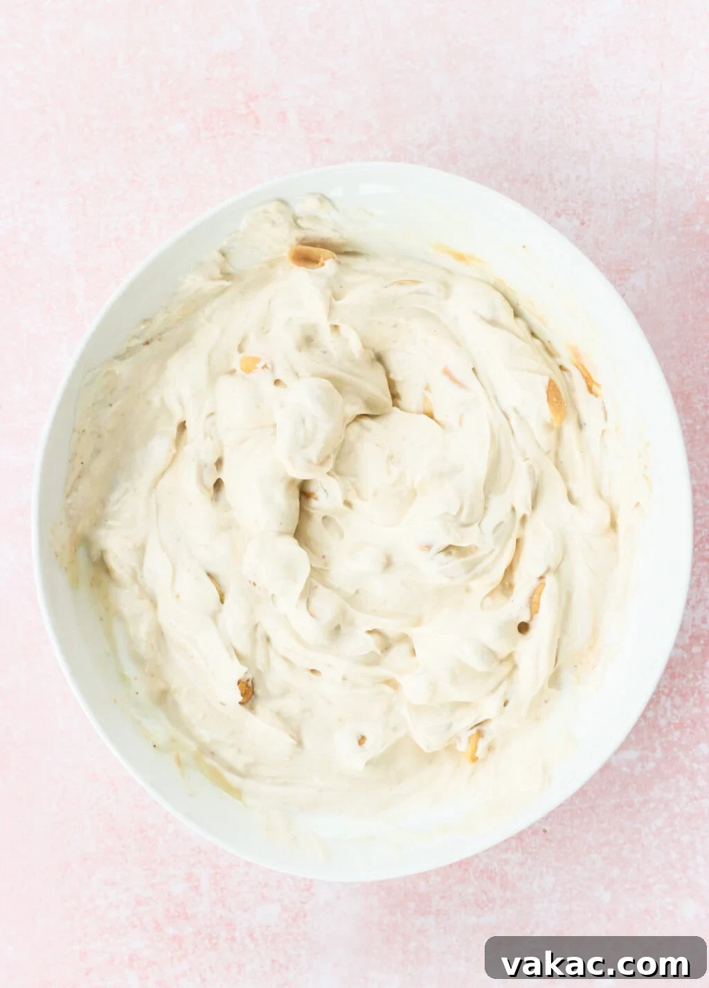 Creamy Peanut Butter and Greek Yogurt Cups with Chocolate Crunch 5 Ingredients for the filling for Peanut Butter & Greek Yogurt Cups with Magic Chocolate Shell mixed in a white bowl on a pink marble counter, including Greek yogurt, smooth peanut butter, maple syrup