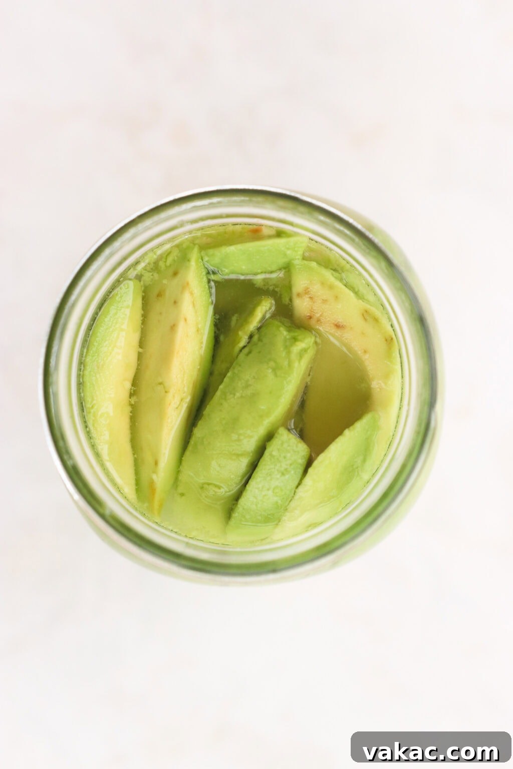 Rapid Tangy Avocados from the Jar 6 A mason jar filled with avocado slices and pickling brine, with its lid securely fastened, ready for a gentle shake