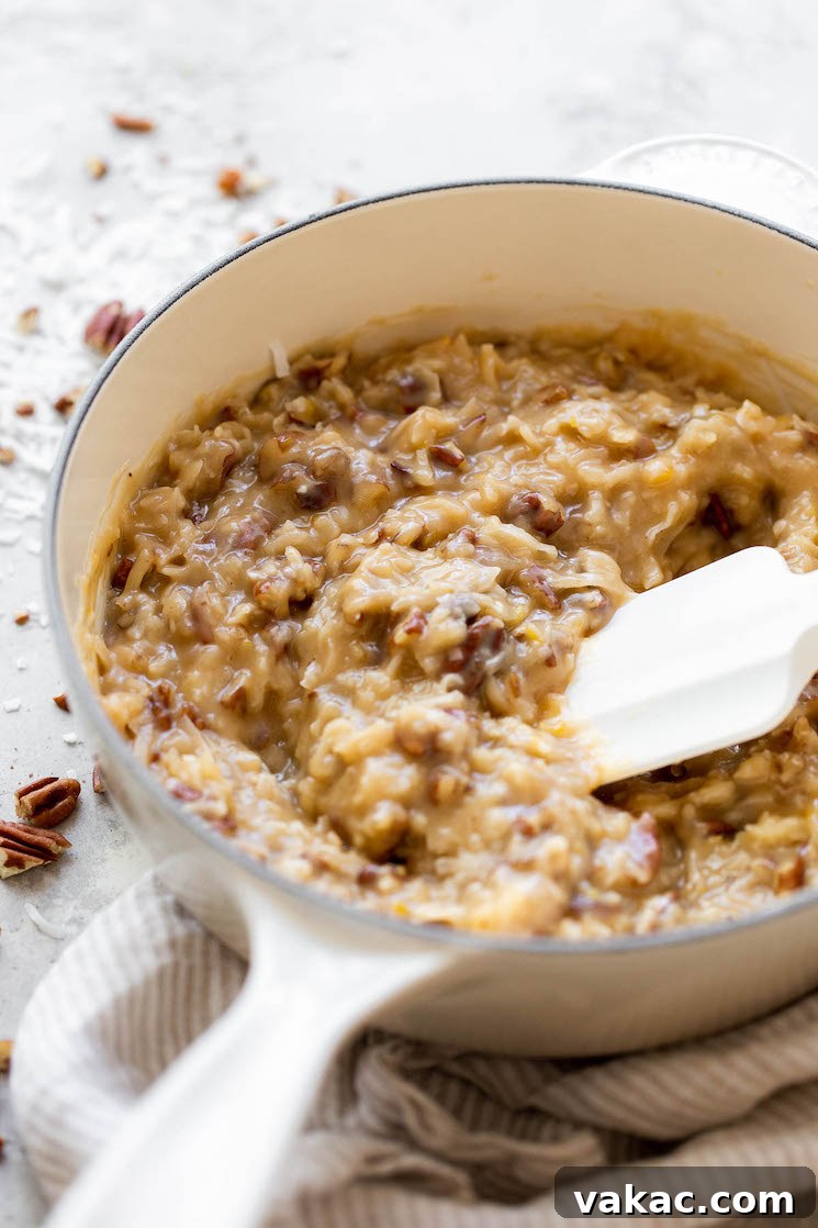 Signature German Chocolate Creation 4 A white pot filled with homemade coconut pecan frosting.