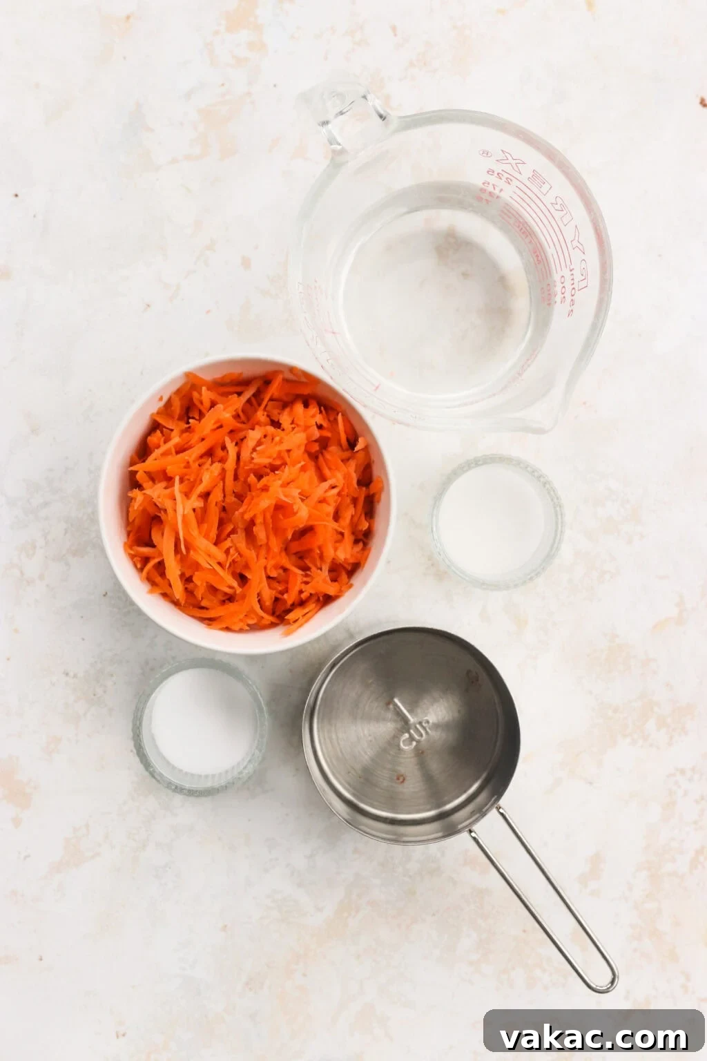 Flash Pickled Shredded Carrots 3 Ingredients for quick pickled shredded carrots, including shredded carrots, salt, sugar, vinegar, and hot water
