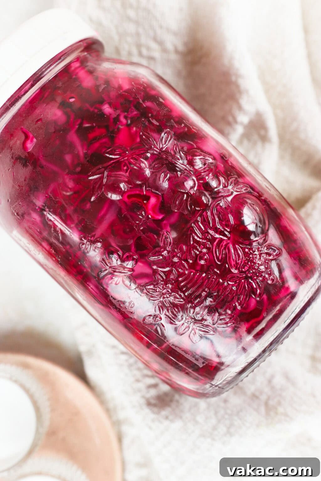 Quick Pickled Red Cabbage Made Easy 6 Quick pickled red cabbage in a glass jar, being shaken to mix ingredients
