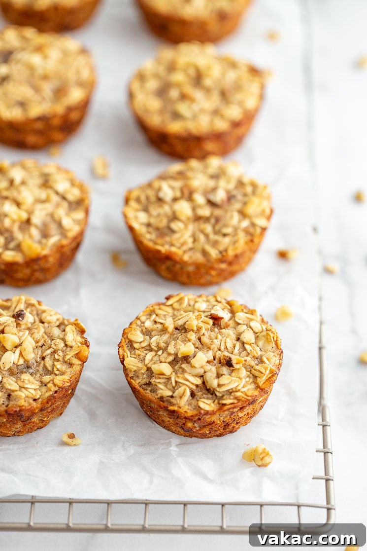 A wire rack neatly displaying the freshly baked banana oatmeal cups, golden and perfectly formed, cooling down after baking.