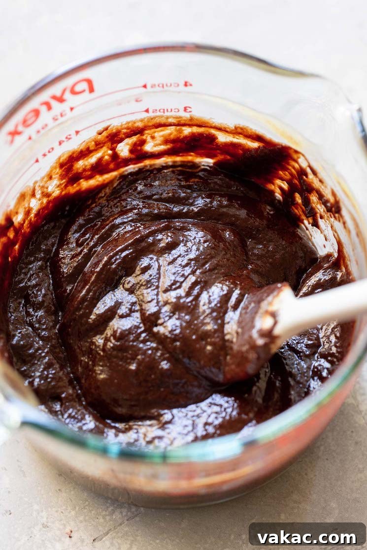 Velvet Chocolate Indulgence 5 A glass mixing bowl with the egg and chocolate mixture being combined.