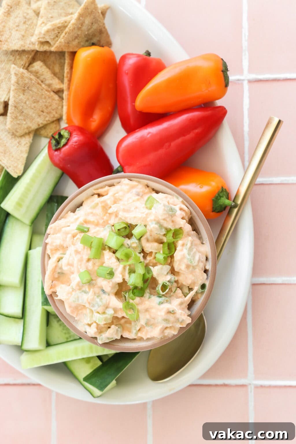 Fast Protein-Packed Buffalo Chicken Salad with Greek Yogurt 2 Quick Buffalo Chicken Salad with Greek Yogurt in a glass bowl on a white serving tray with celery, peppers, and crackers on the side