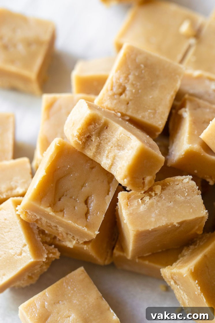 Ultimate Peanut Butter Fudge 6 Pieces of Peanut Butter Fudge stacked with the top piece having a bite taken out.