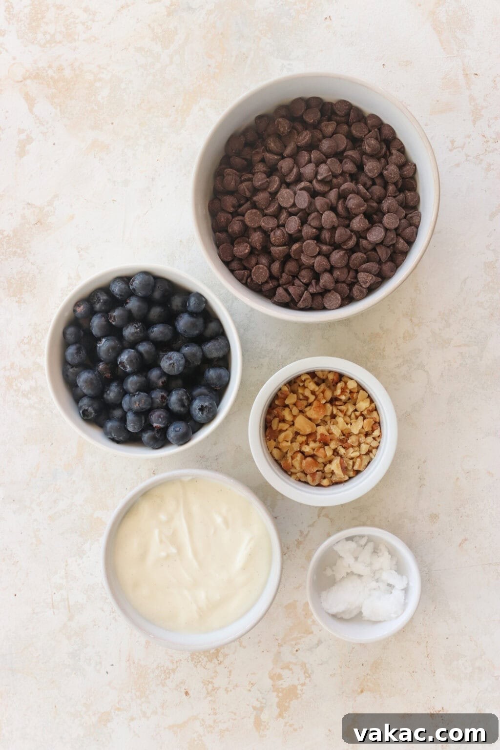 Effortless High-Protein Frozen Greek Yogurt Blueberry Bites 3 Ingredients for Frozen Blueberry Greek Yogurt Clusters, including blueberries, walnuts, vanilla Greek yogurt, salt, chocolate chips, coconut oil