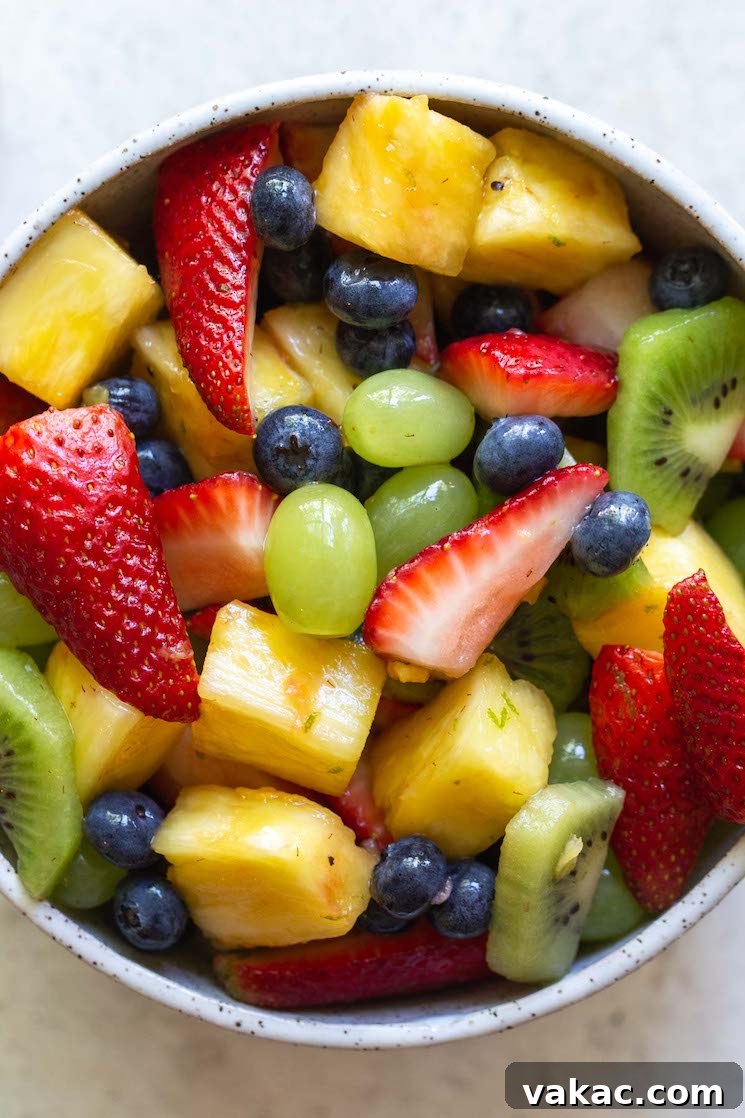 Sun Kissed Fruit Delight 6 A captivating close-up image of a fresh fruit salad nestled within a rustic clay bowl, highlighting the vibrant colors and varied textures of the individual fruits.