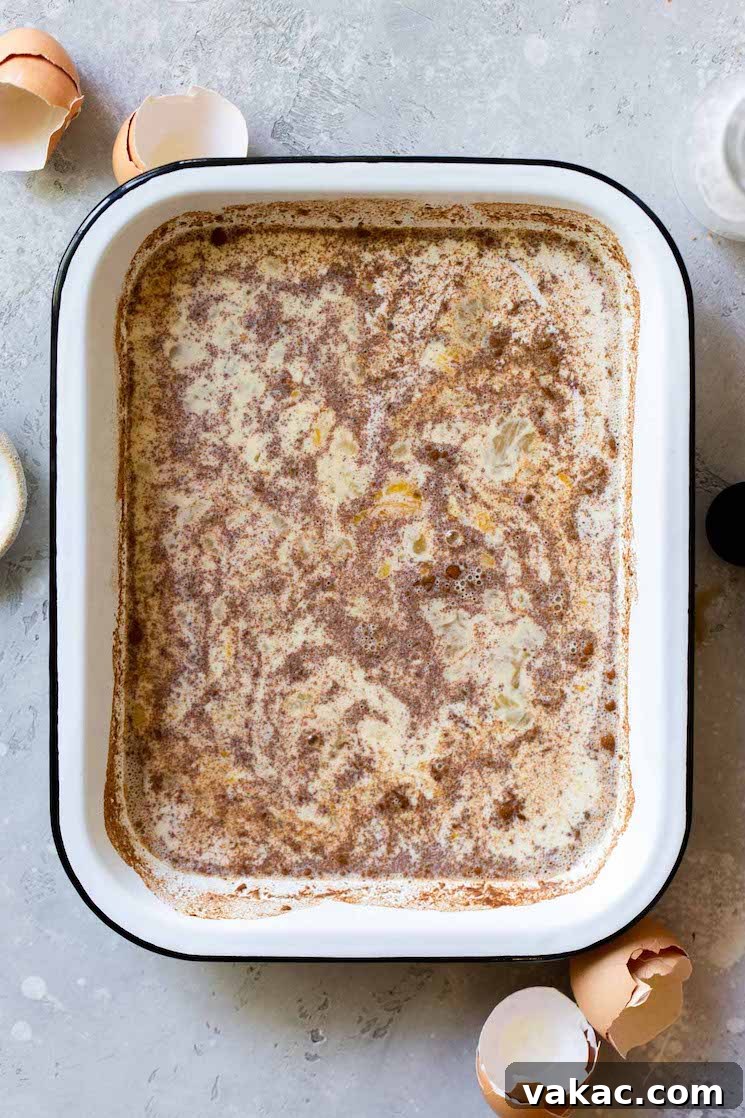 Unforgettable French Toast 4 A shallow baking pan filled with the perfectly mixed egg custard, ready for bread slices to be dipped into before cooking into golden French toast.