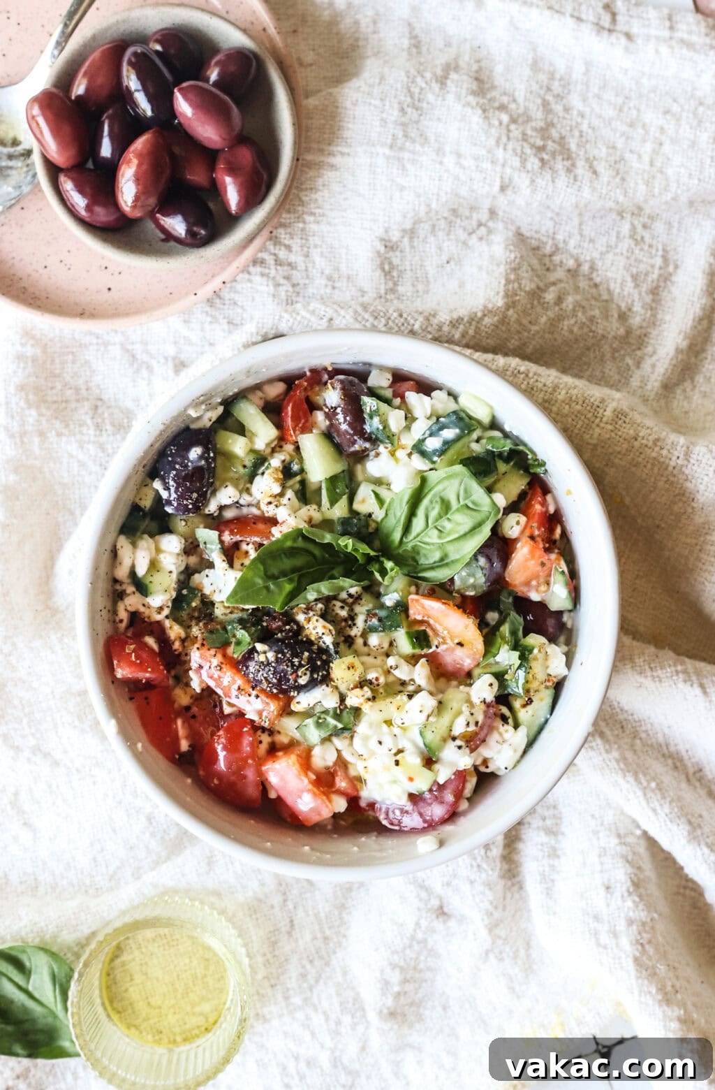 Zesty Mediterranean Cottage Cheese Salad 7 Easy Greek-Inspired Cottage Cheese Salad in a white bowl, garnished with fresh dill.
