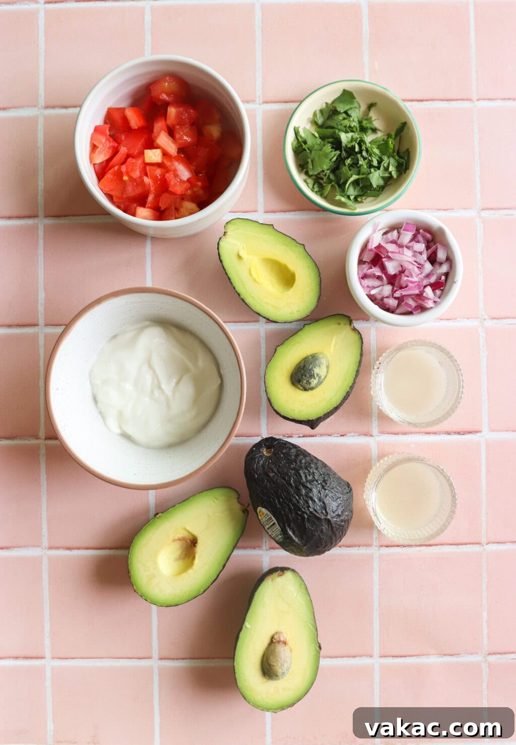 Speedy Creamy Greek Yogurt Guacamole 4 Ingredients for 5-Minute Greek Yogurt Guacamole Dip displayed in small white bowls, including ripe avocados, fresh lime juice, lemon juice, Greek yogurt, diced Roma tomato, diced red onion, chopped cilantro, salt, and pepper