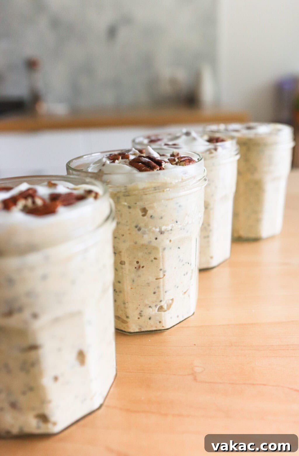 Effortless Autumn Bliss: Pumpkin Pie Spice Overnight Oats 6 Easy & Filling Pumpkin Pie Spice Overnight Oats in glass jars on a pink counter