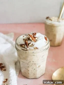 Easy & Filling Pumpkin Pie Spice Overnight Oats in glass jars on a pink counter