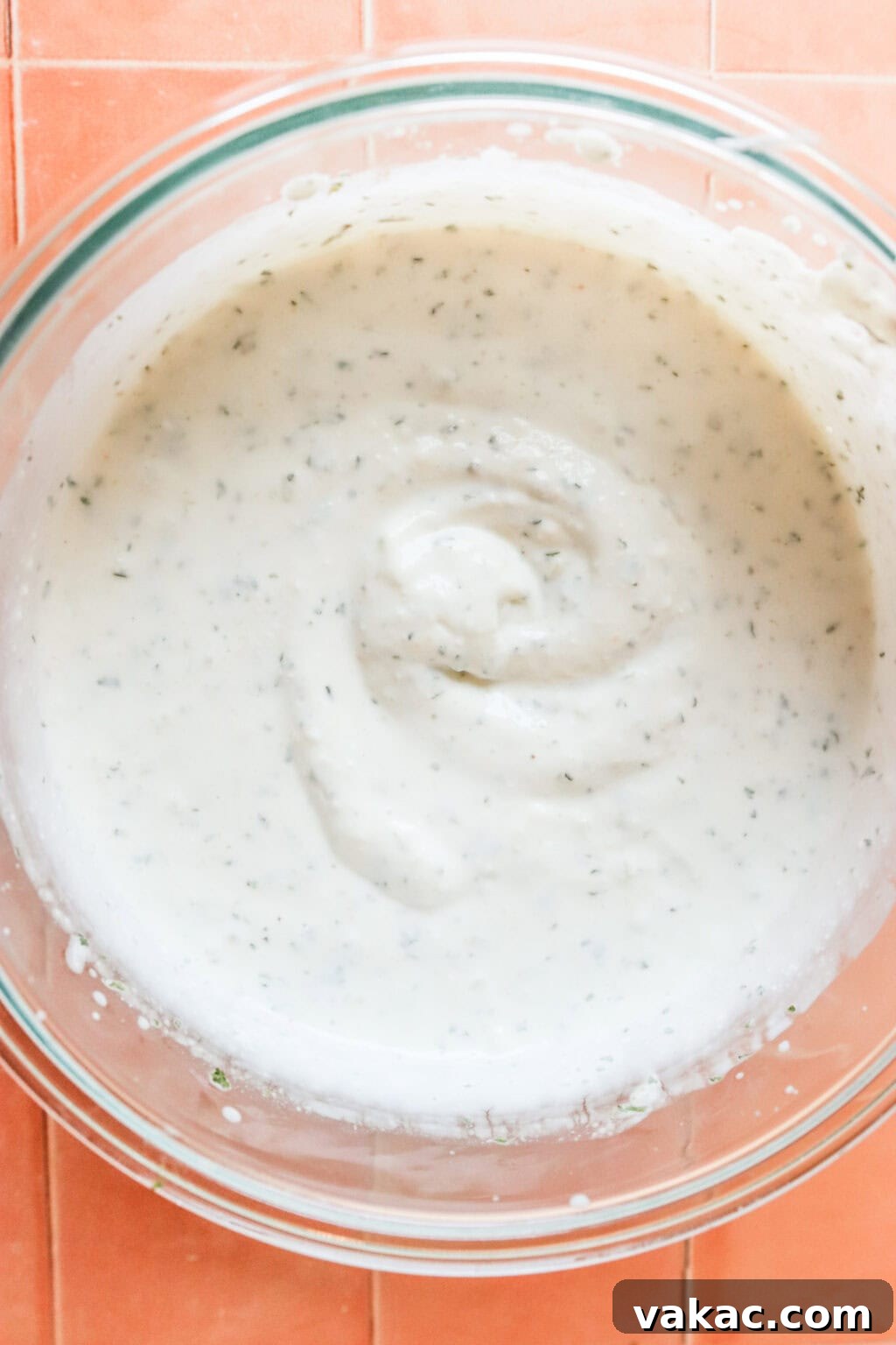 Quick 3-Ingredient Protein Packed Cottage Cheese Ranch Dip 5 ingredients blended together in a glass bowl on orange countertop