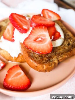 Final product of sheet pan French toast with whipped Greek yogurt and strawberries on top.