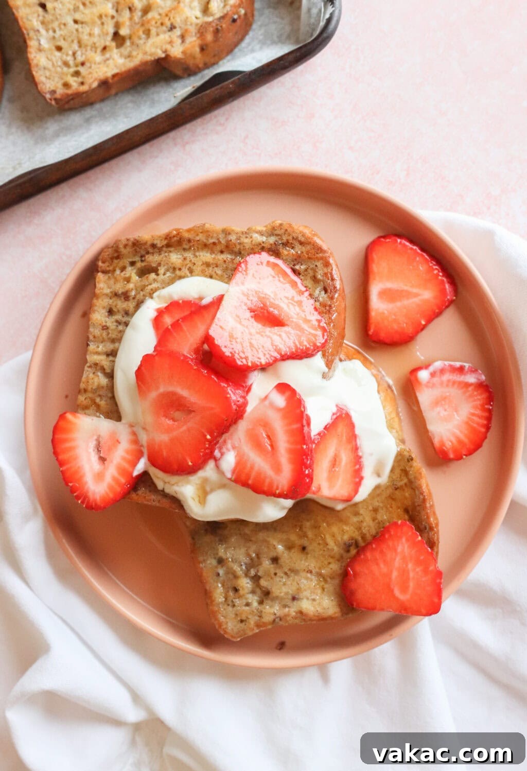 Pillowy Cinnamon-Kissed Sheet Pan French Toast Bake 7 Final product of sheet pan French toast with whipped Greek yogurt and strawberries on top, served fresh.