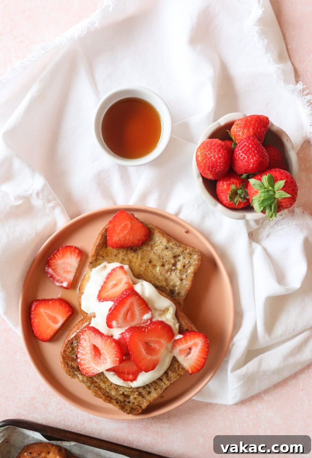 Pillowy Cinnamon-Kissed Sheet Pan French Toast Bake 8 Another view of the final sheet pan French toast, garnished with Greek yogurt whip and fresh strawberries.