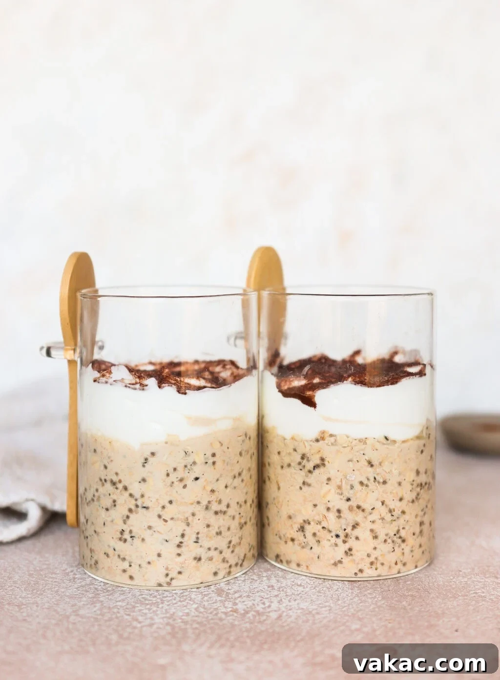 Effortless Tiramisu Overnight Oats with Greek Yogurt 5 Side shot of two glass jars containing layered Tiramisu Overnight Oats, showing the creamy consistency.