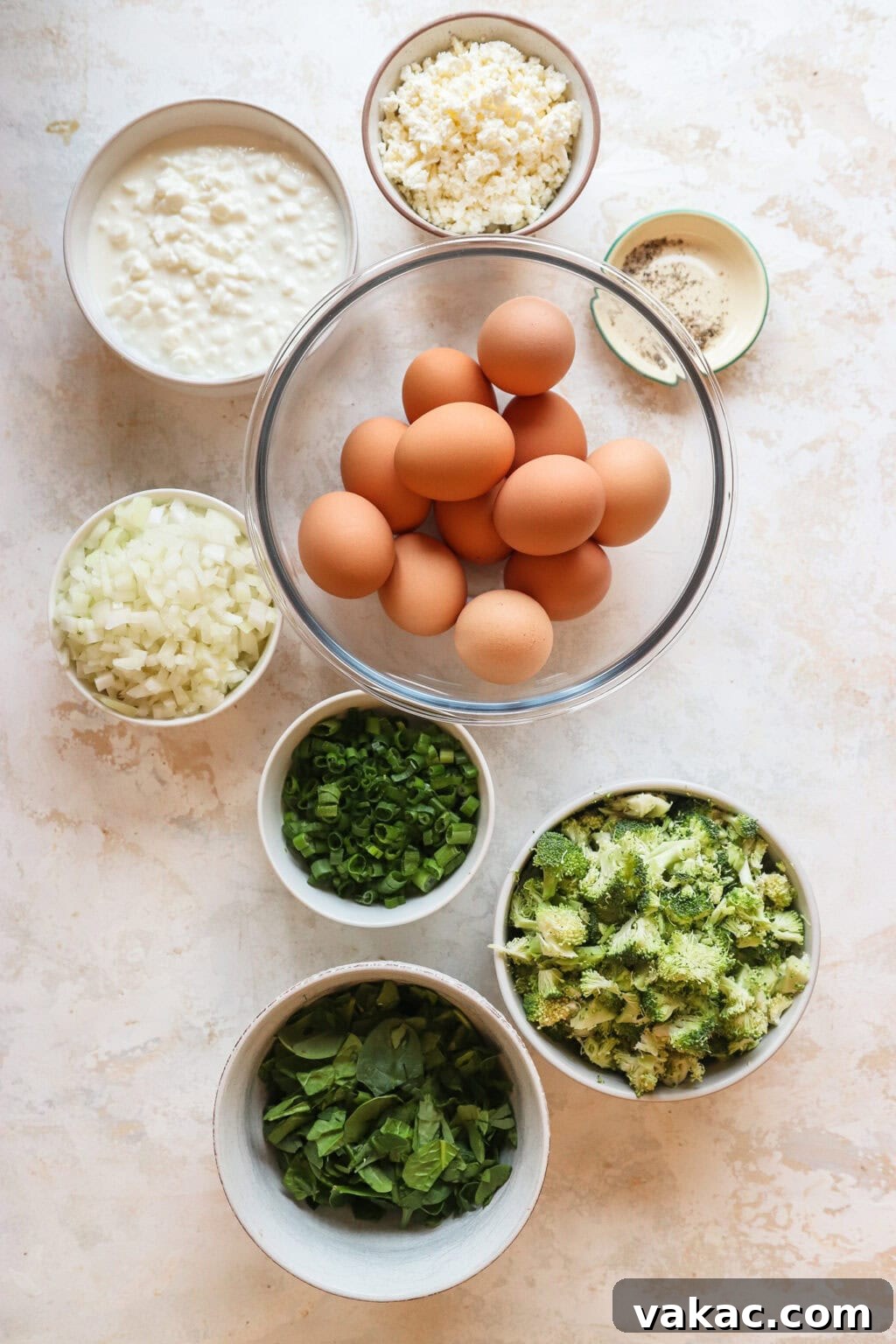 Hearty Protein Egg and Cottage Cheese Bake 3 All the fresh ingredients for the Egg and Cottage Cheese Breakfast Bake, neatly arranged in separate bowls, ready for preparation.
