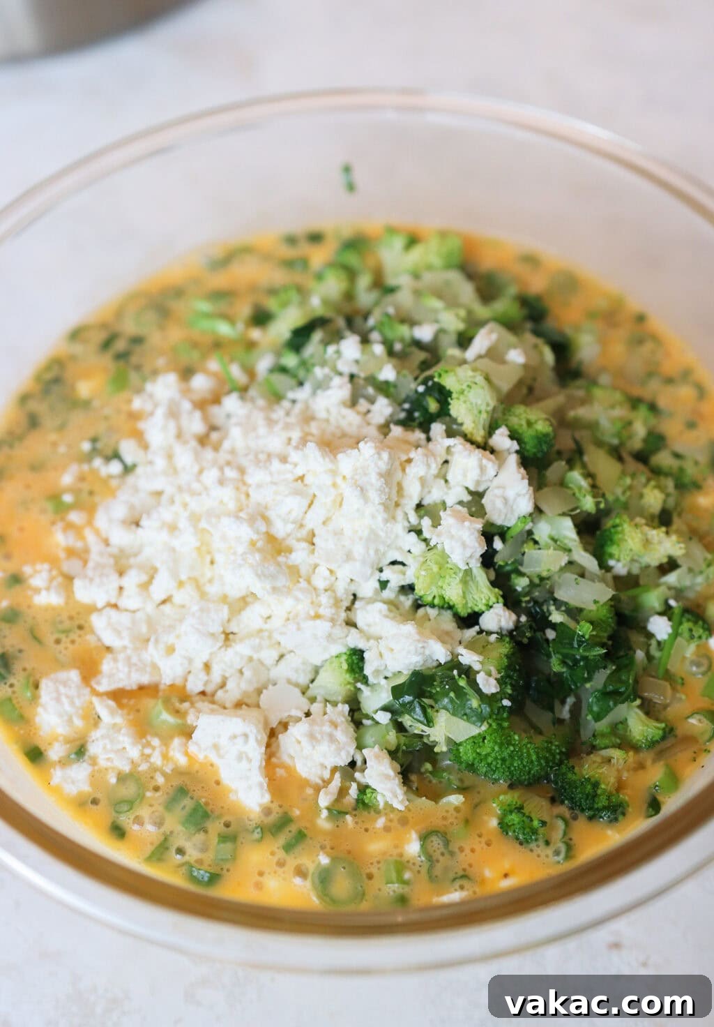 Hearty Protein Egg and Cottage Cheese Bake 6 All the ingredients for the Egg and Cottage Cheese Breakfast Bake in a large glass bowl before being mixed together.