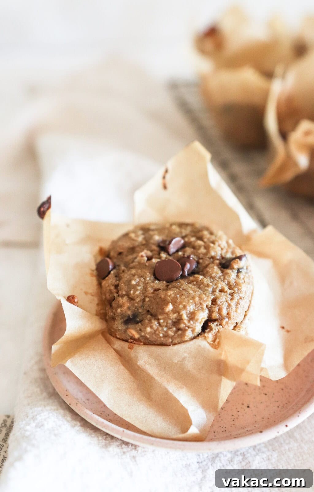 Protein-Packed Banana Cottage Cheese Morning Muffins 8 finished cottage cheese chocolate chip muffins on a pink plate