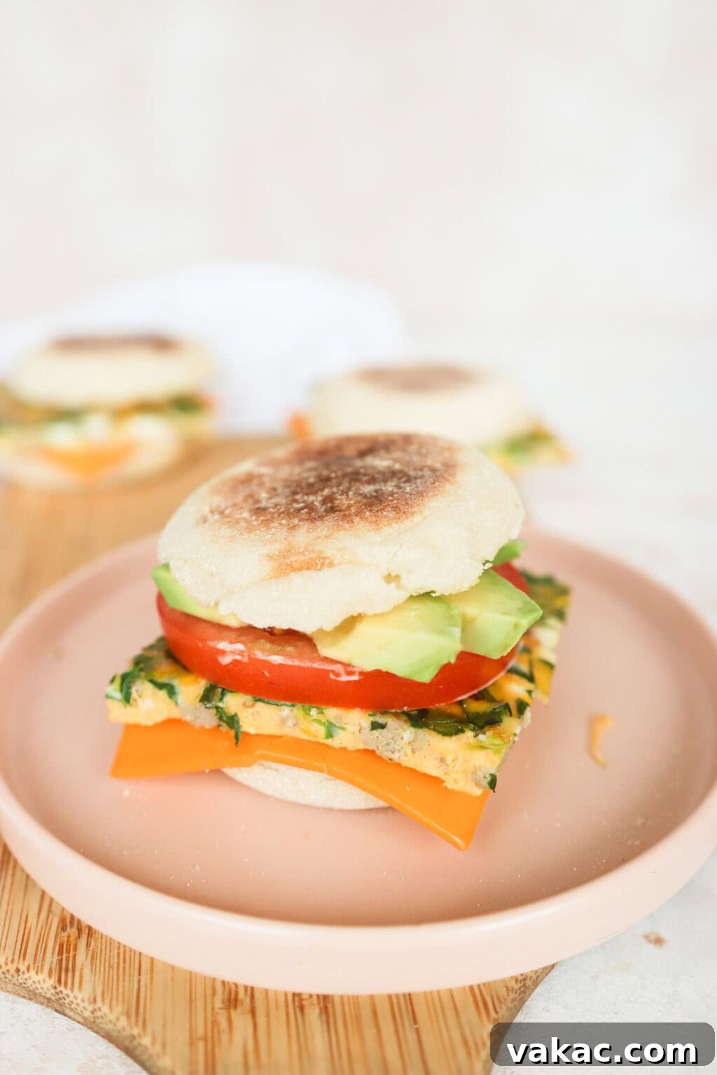 Effortless Turkey Sausage Breakfast Sandwiches 2 Close-up of a perfectly assembled turkey sausage breakfast sandwich on a pink plate, ready to be enjoyed.