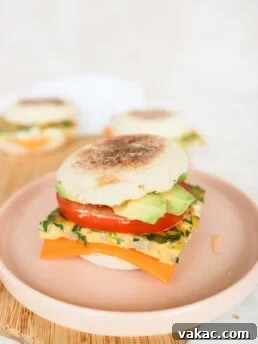Close-up of a perfectly assembled turkey sausage breakfast sandwich on a pink plate