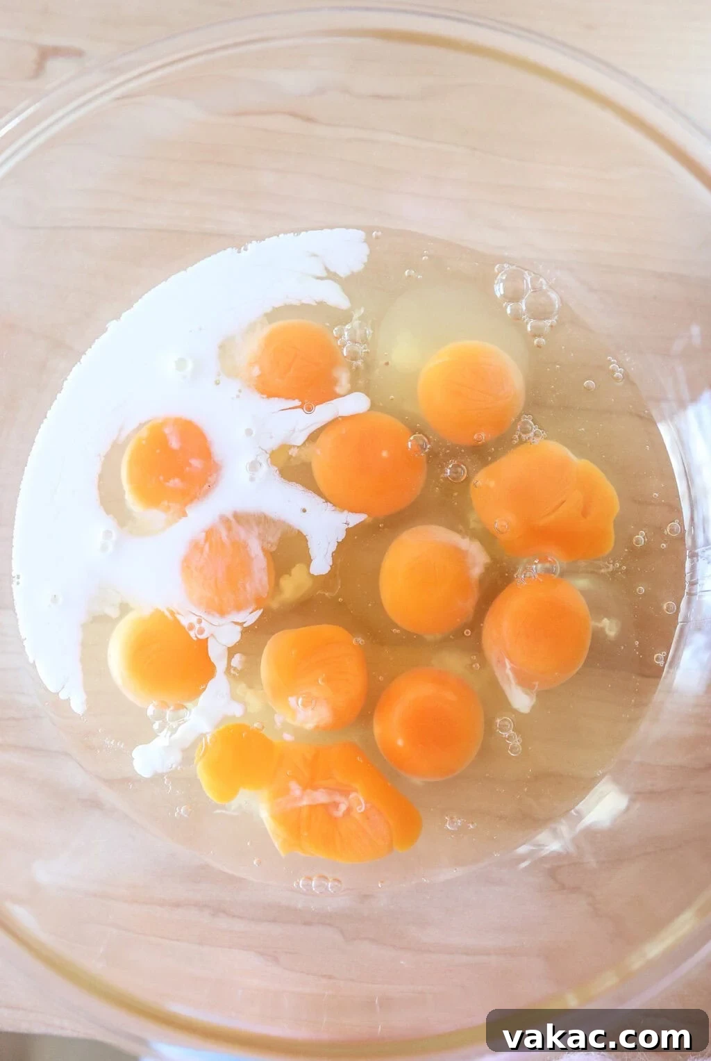 Effortless Turkey Sausage Breakfast Sandwiches 5 Fresh eggs and milk in a glass bowl, ready to be whisked for the breakfast sandwich egg bake.