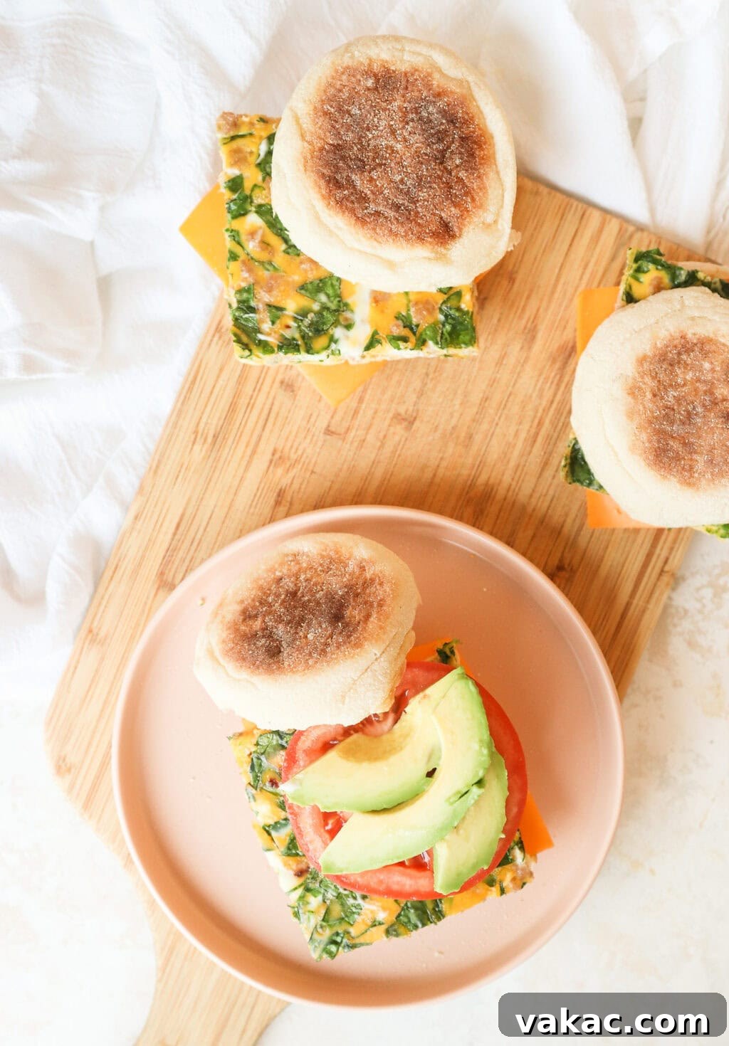 Effortless Turkey Sausage Breakfast Sandwiches 9 Overhead view of an open turkey sausage breakfast sandwich, showcasing the egg, avocado, and tomato on an English muffin.