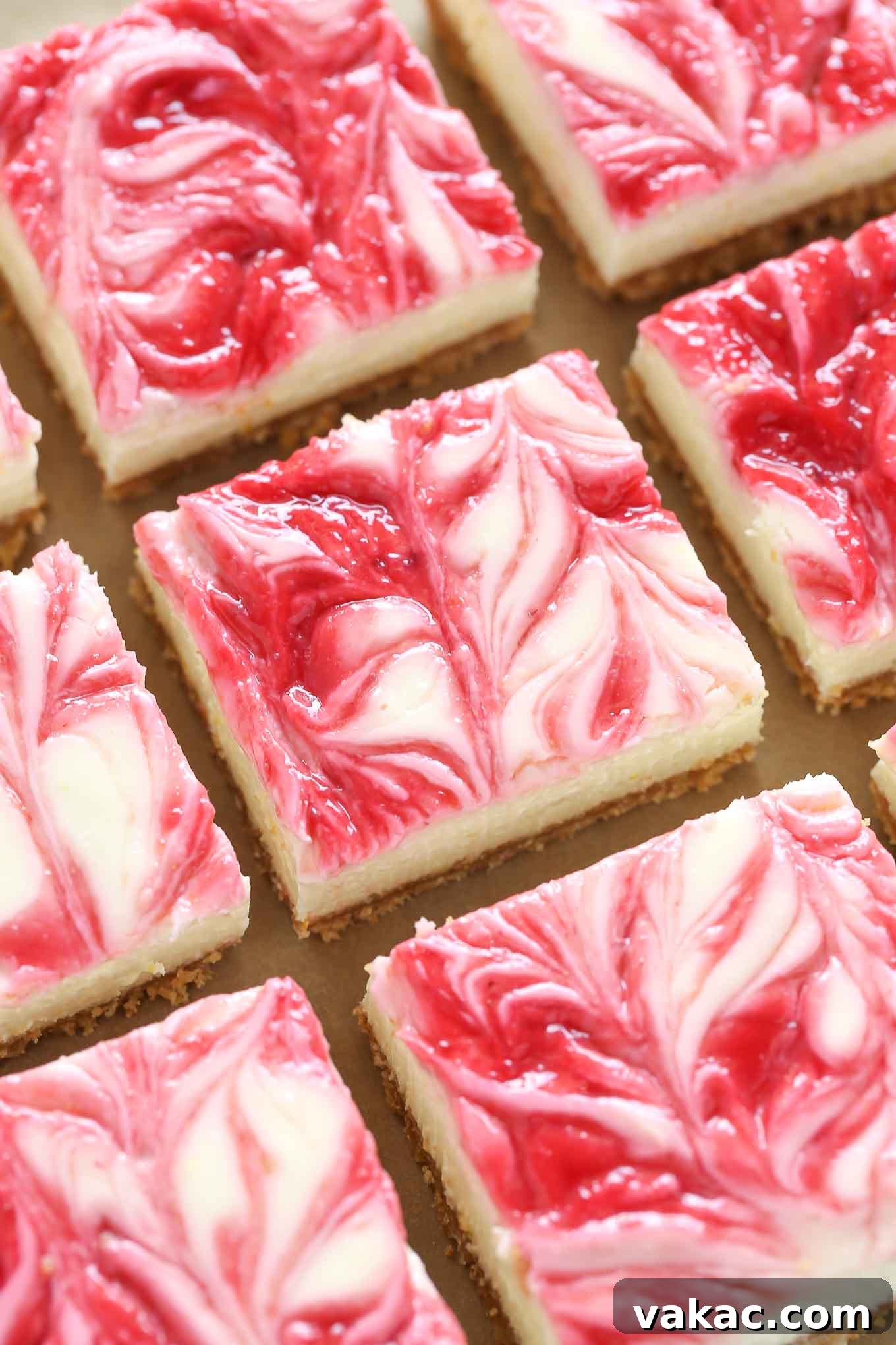 Zesty Lemon Raspberry Cheesecake Bars 3 An overhead shot showcasing perfectly arranged rows of vibrant lemon raspberry cheesecake bars, highlighting their appealing swirl pattern.