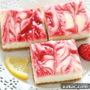 Zesty Lemon Raspberry Cheesecake Bars 5 A close-up shot of a single Lemon Raspberry Cheesecake Bar, highlighting the creamy texture and distinct layers of crust, lemon cheesecake, and raspberry swirl.
