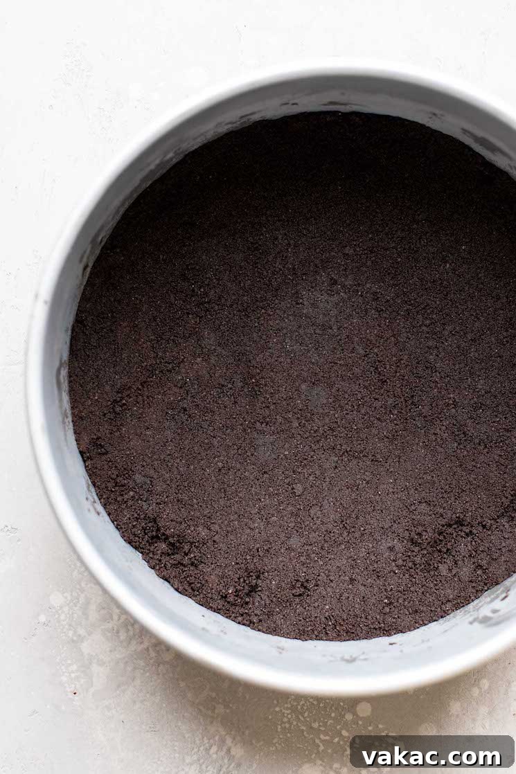 Crimson Dream Cheesecake 4 Overhead view of an Oreo crust packed into the bottom of a springform pan.