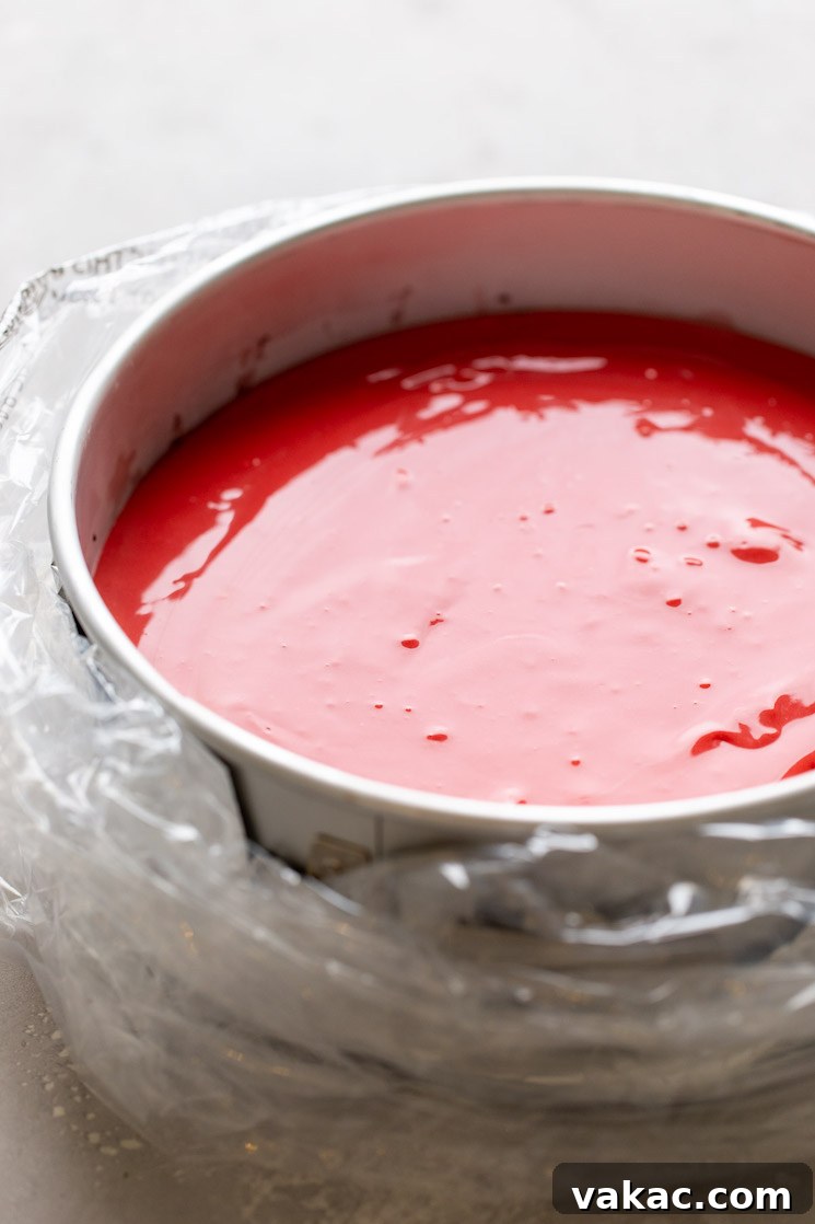 Crimson Dream Cheesecake 6 A springform pan wrapped in an oven bag and filled with red velvet cheesecake batter.