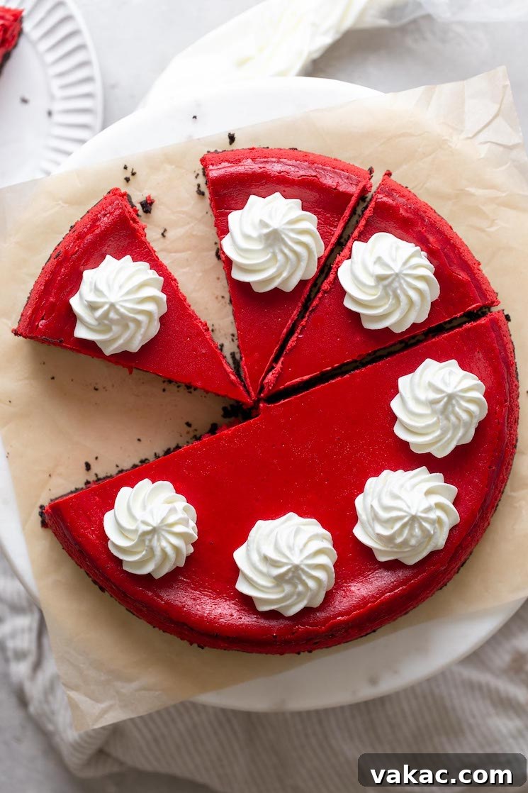 Crimson Dream Cheesecake 7 Overhead view of a red velvet Oreo cheesecake that's been partially sliced.