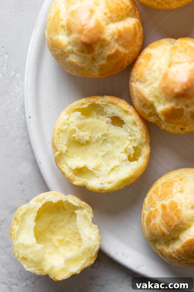 Sweet Cream Clouds 8 Overhead view of unfilled cream puff shells. One shell has been split in half.
