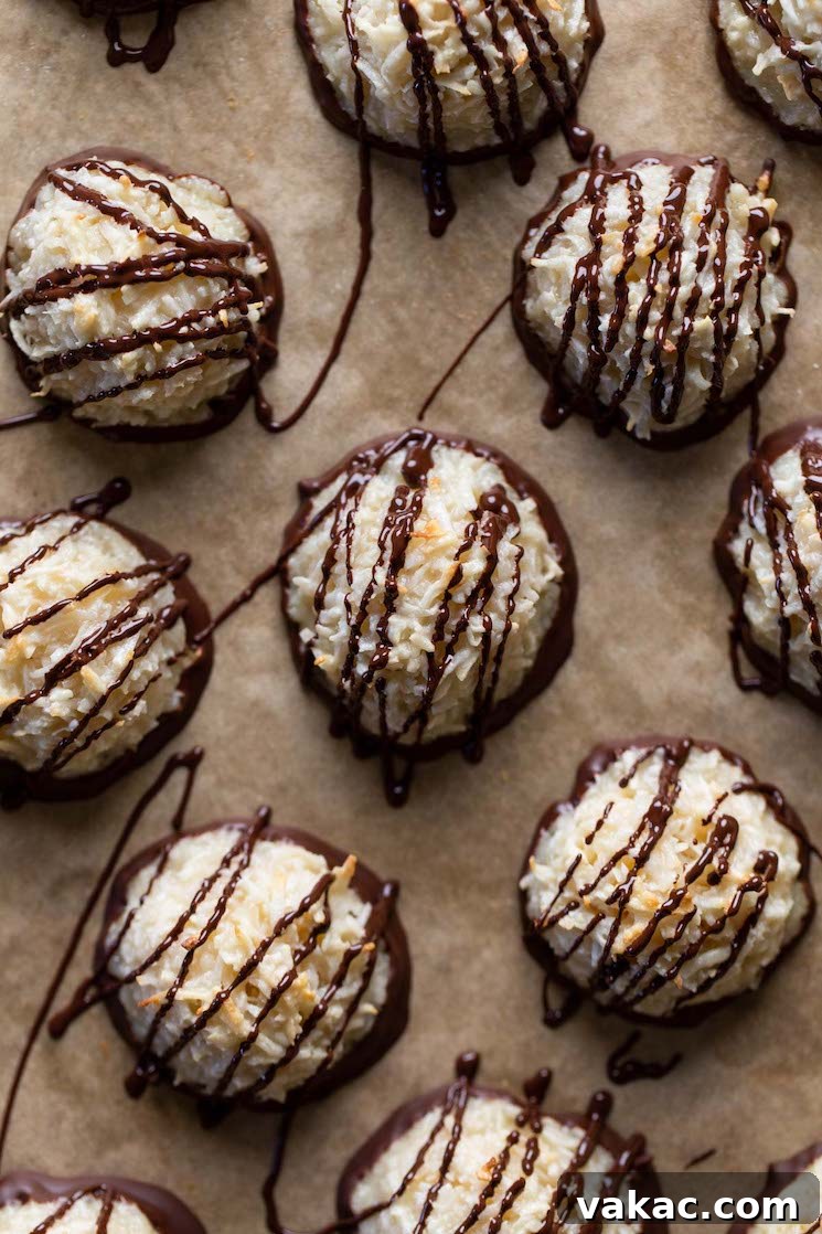 Chewy Toasted Coconut Macaroons 2 Overhead view of chocolate coconut macaroons on parchment paper.