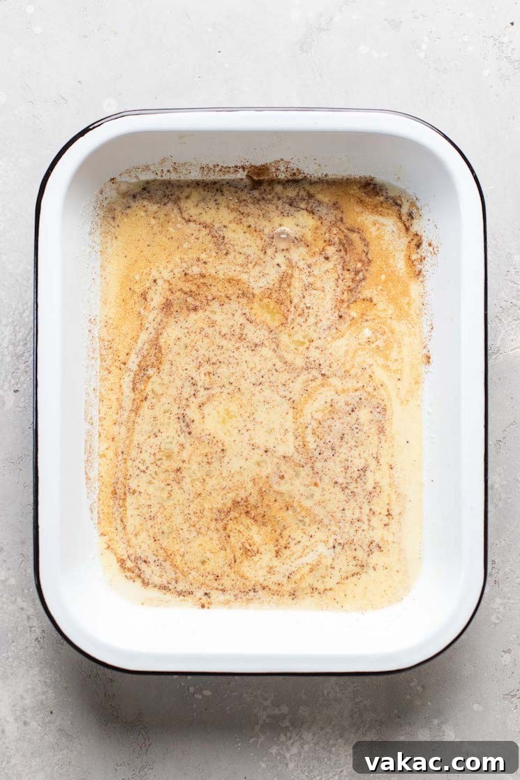 Overhead view of french toast batter in a large baking dish.