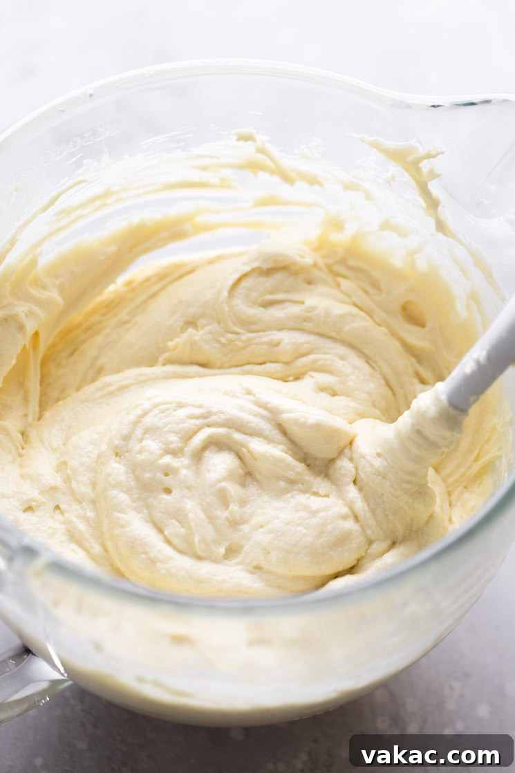 Marbled Perfection 4 Vanilla cake batter in a glass mixing bowl with a rubber spatula.