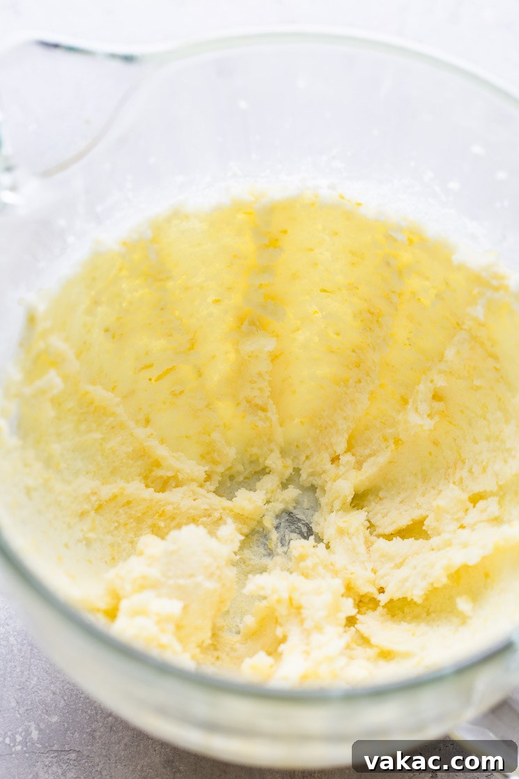 Sunshine Lemon Delight 4 A glass mixing bowl with creamed butter and sugar.
