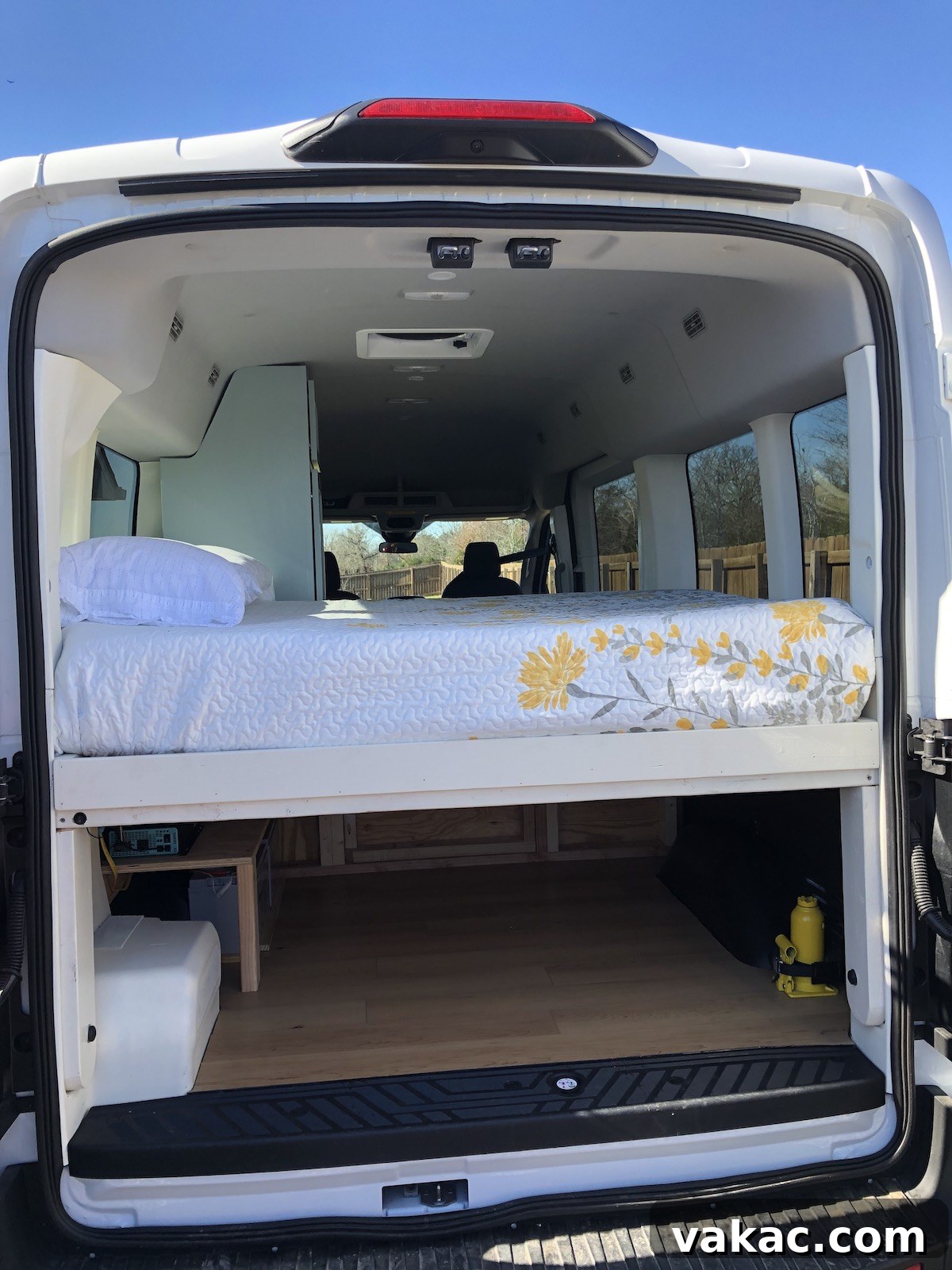 Recipes and Real Life 5 The organized back of a cleverly renovated cargo van, showcasing the ample and well-designed storage space conveniently located underneath the built-in bed.