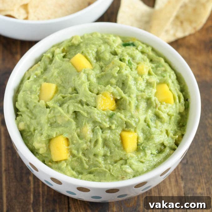 This mango guacamole makes a fun appetizer for any party and comes together in just a few minutes!  Serve it with some tortilla chips for a quick and easy appetizer or snack.