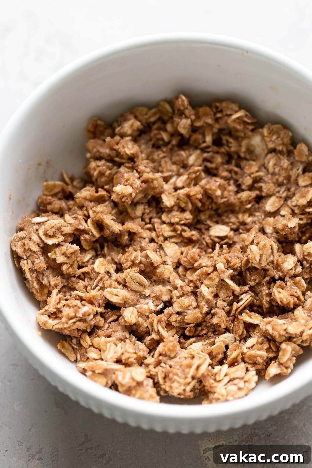 Warm Spiced Apple Bake 5 A white bowl full of oatmeal crisp mixture.
