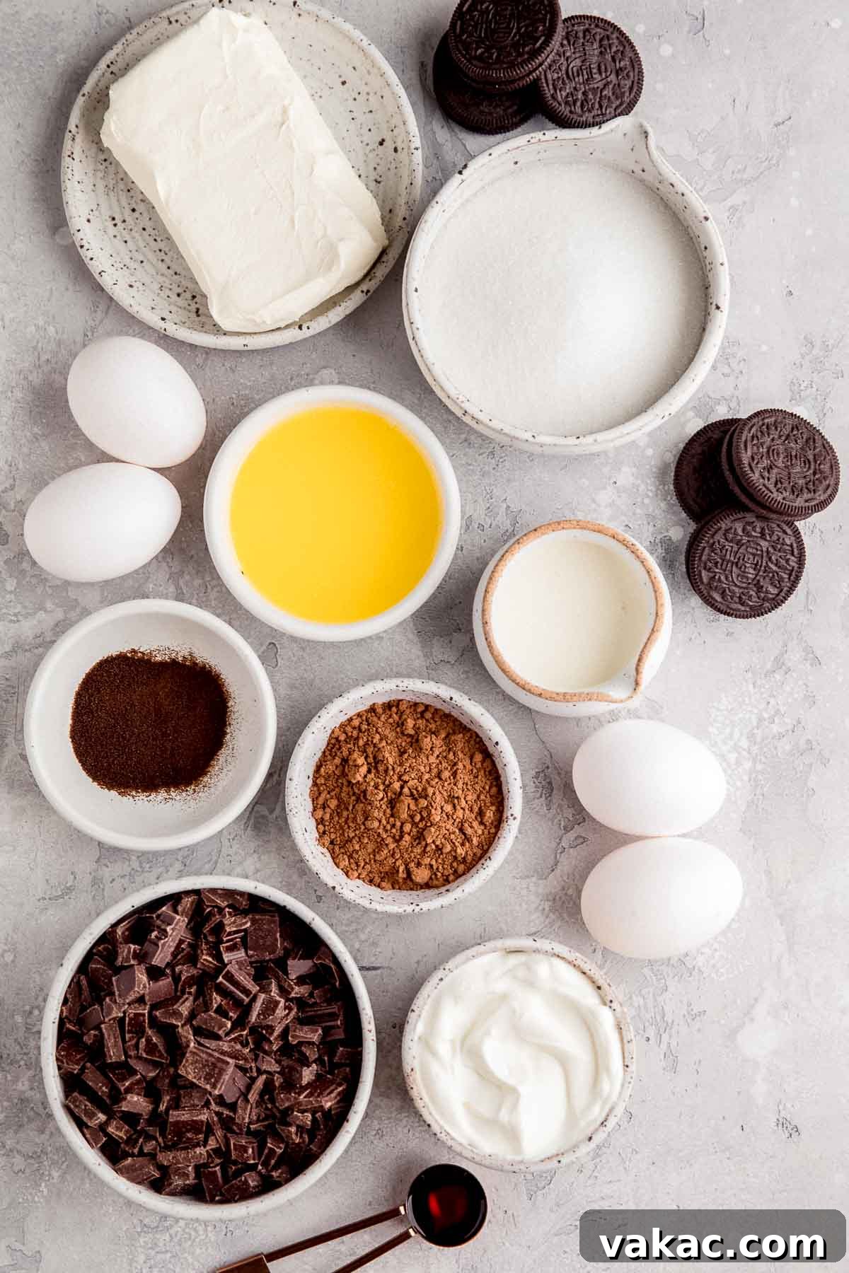 An overhead view of the essential ingredients needed to create a delicious chocolate cheesecake, neatly arranged on a kitchen surface, highlighting freshness and quality.